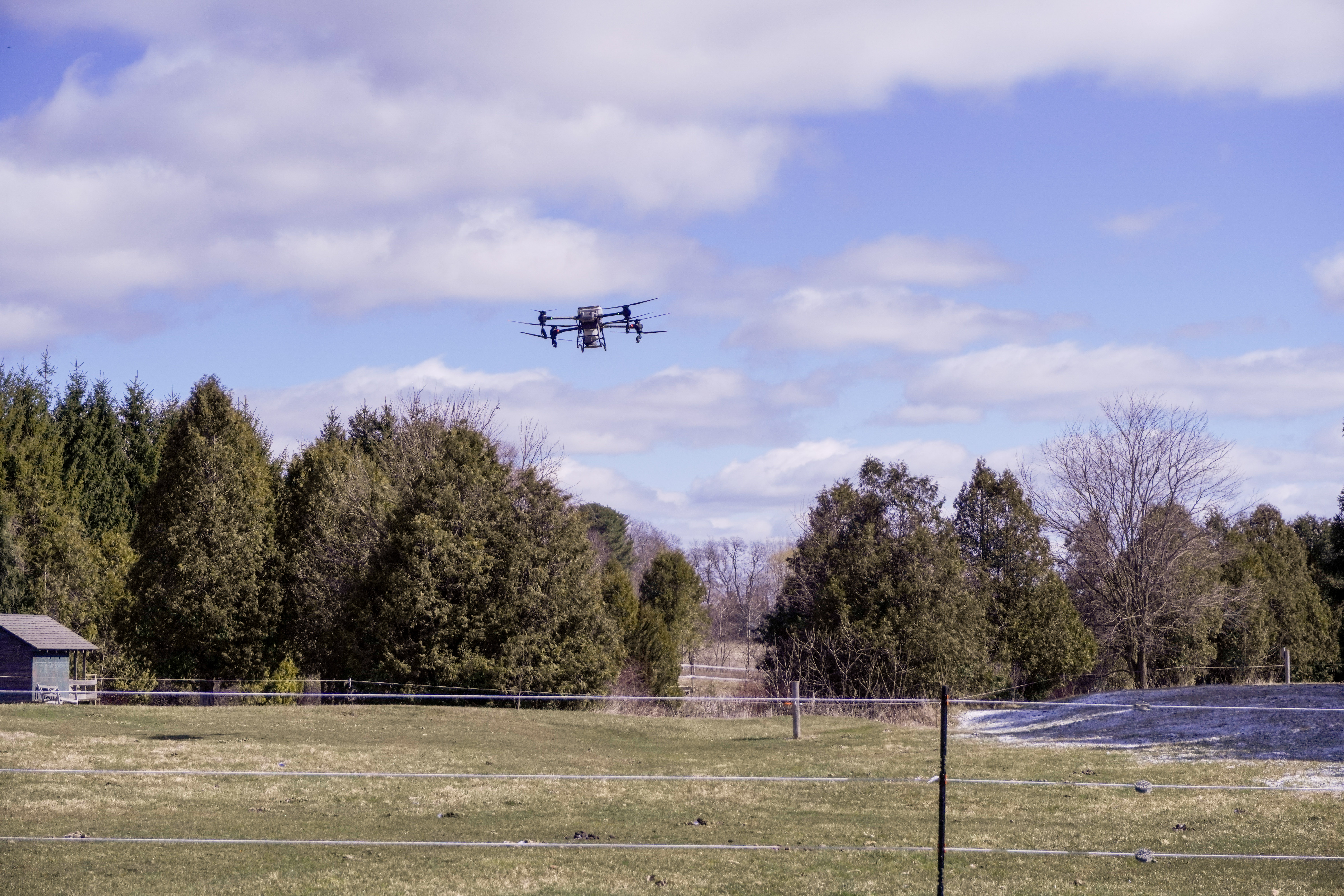 The T50 flying over the pasture landscape on a clear March day