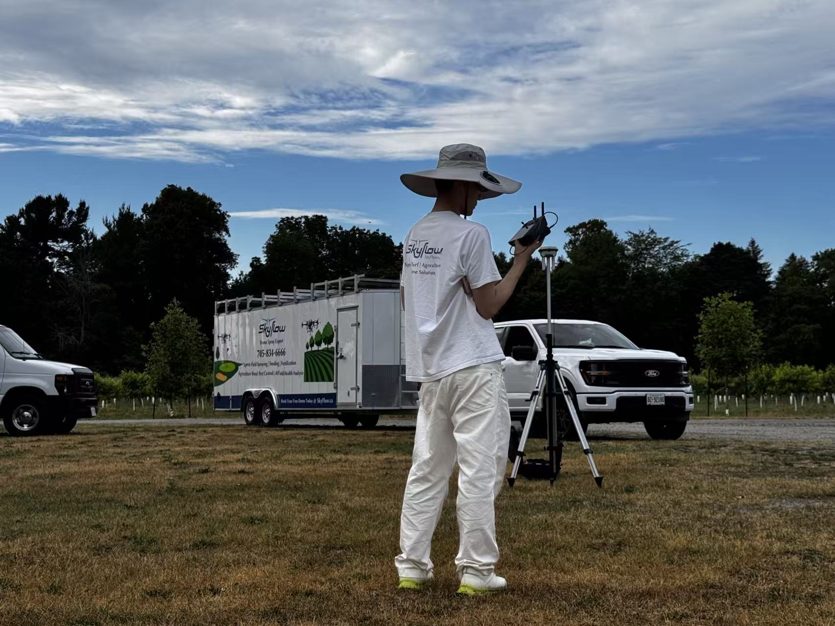 SkyFlow team in the field with a DJI Agras drone