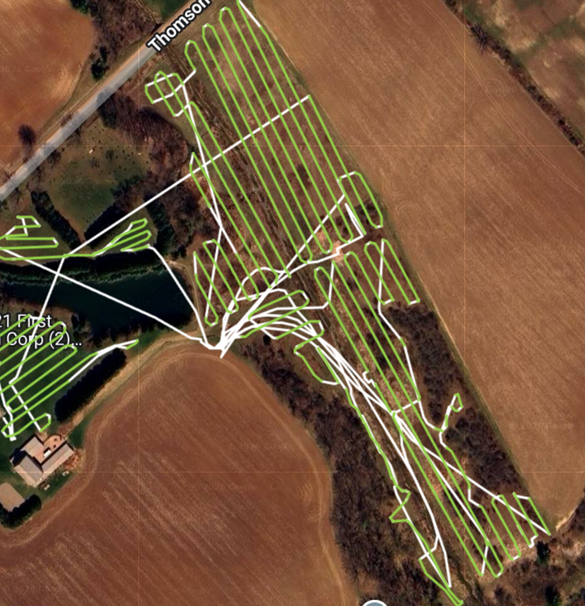 Satellite view showing the completed flight paths — green lines show the application routes across the fragmented pasture