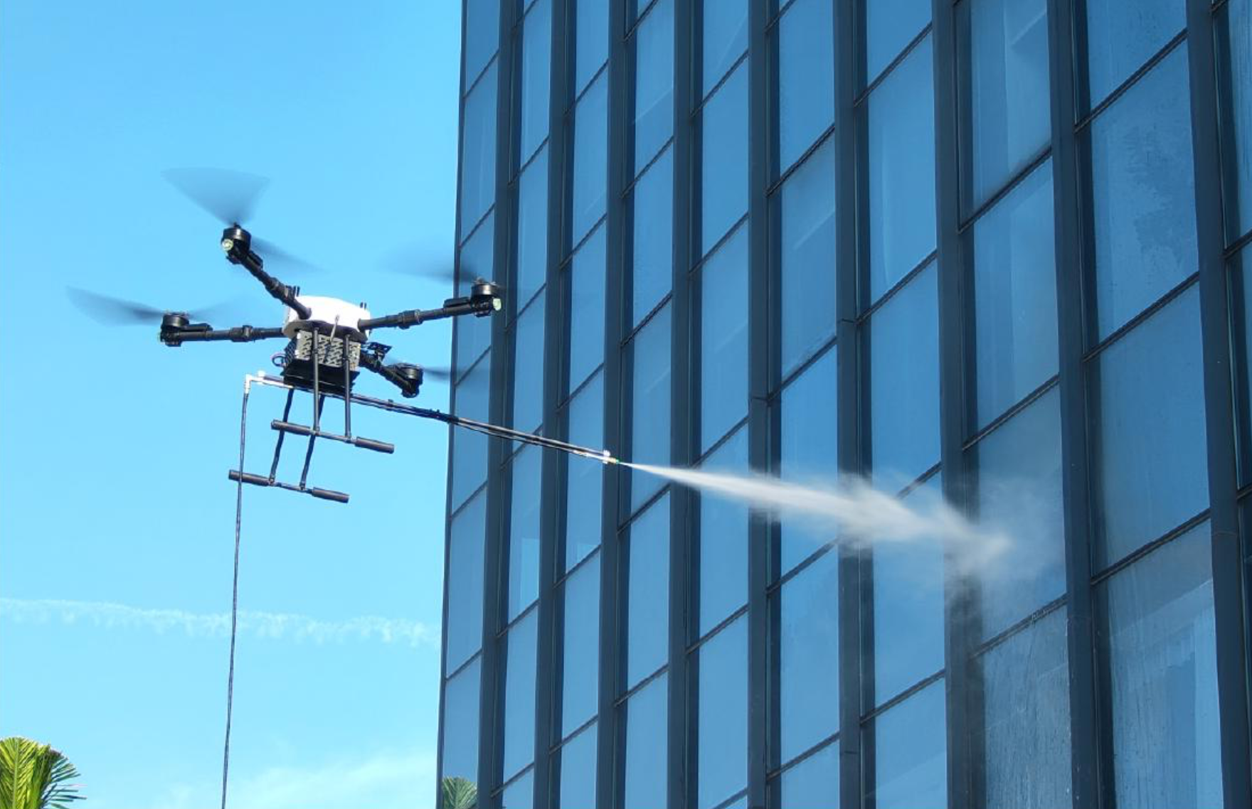 Drone cleaning exterior of a commercial building