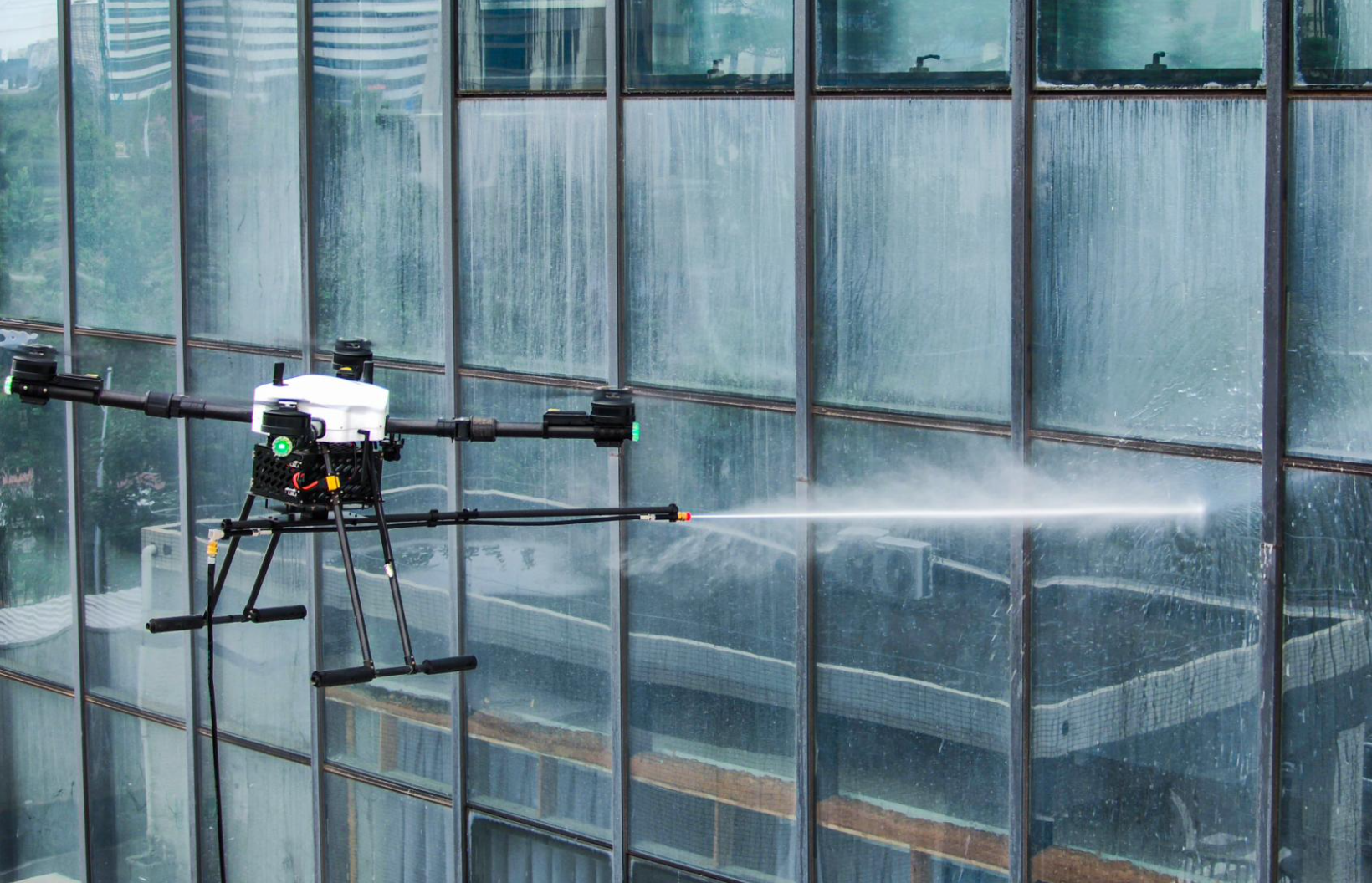 Cleaning drone working on glass surface of a high-rise building