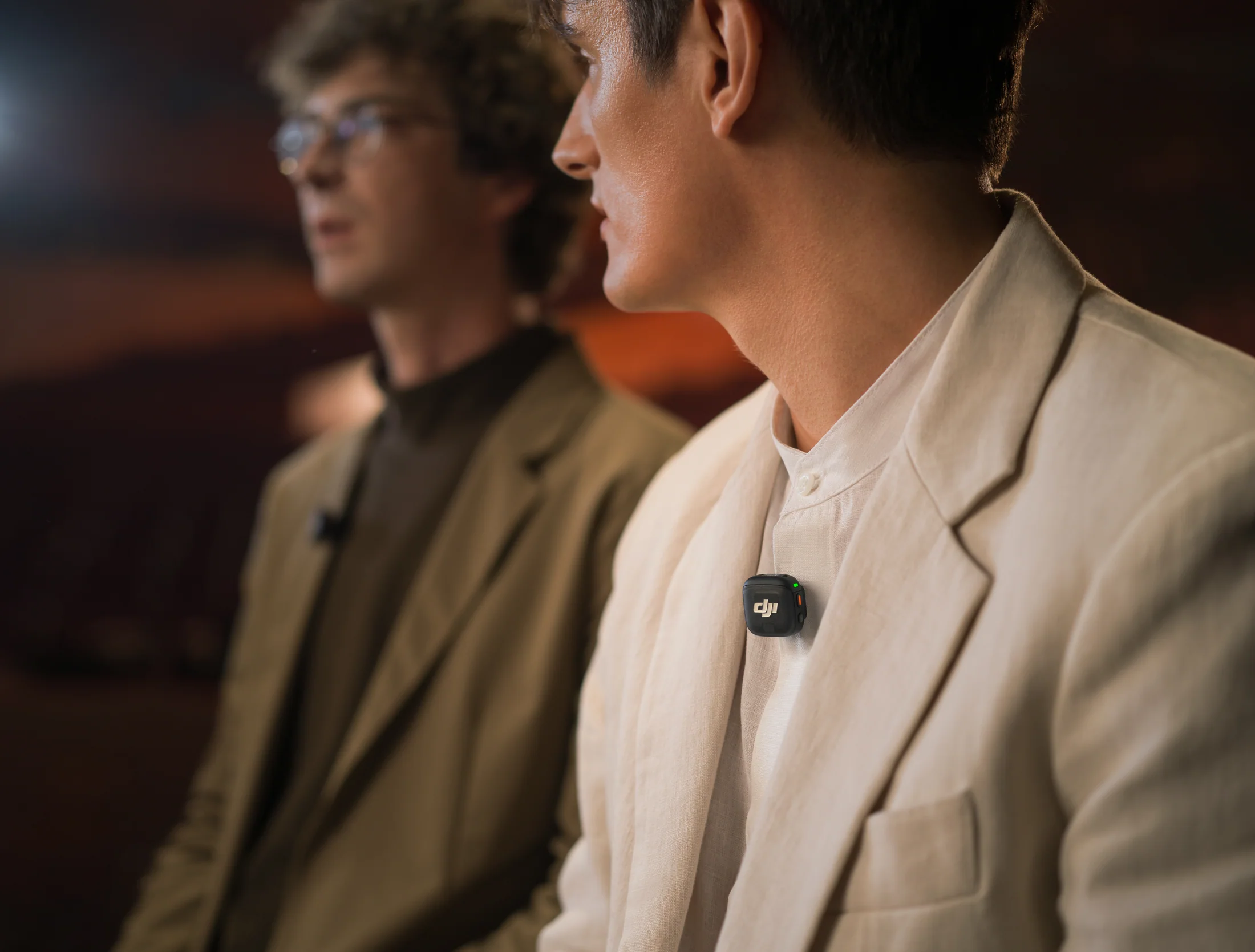 Two speakers wearing DJI Mic 3 transmitters