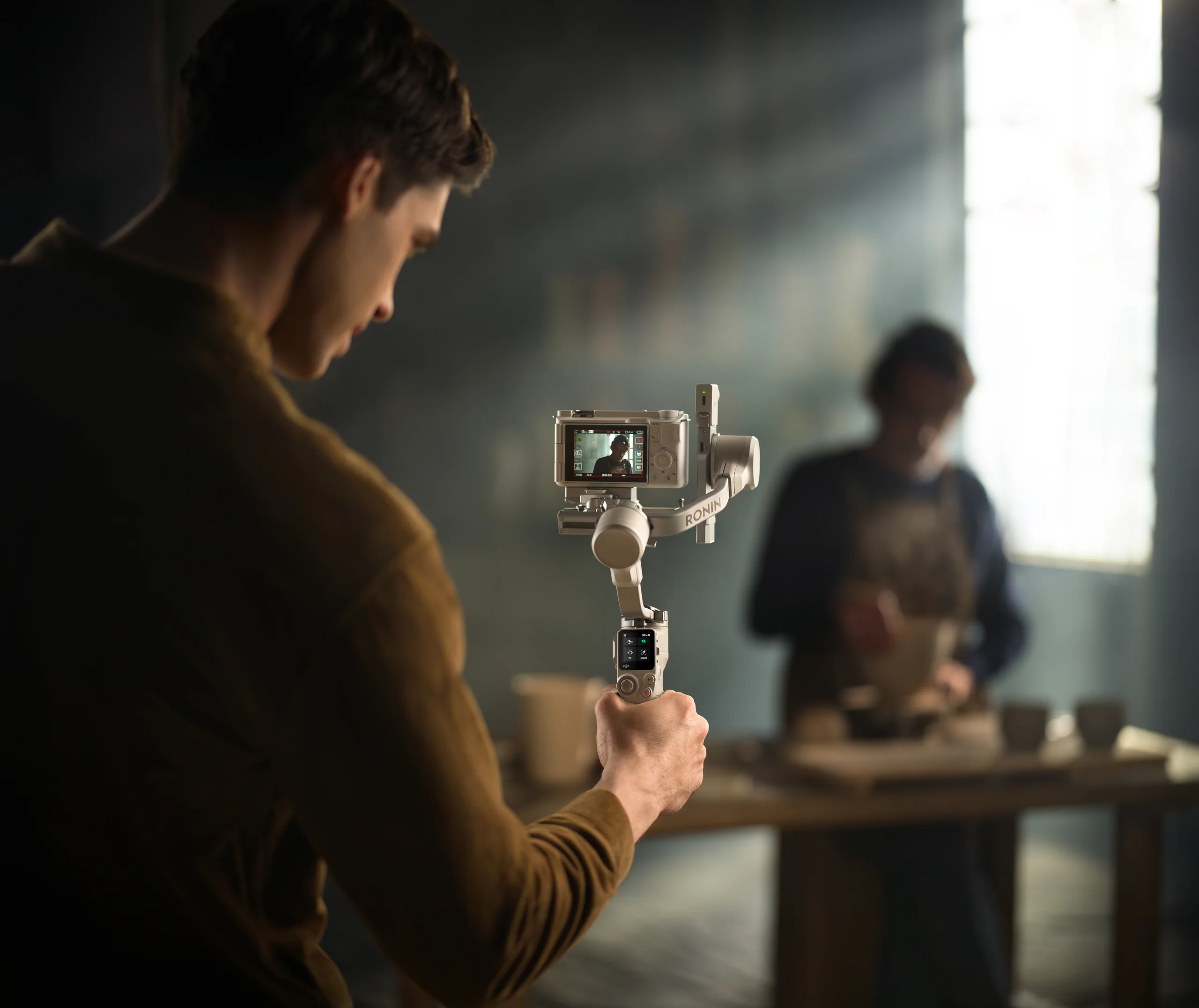 Solo creator operating a compact tracked camera setup
