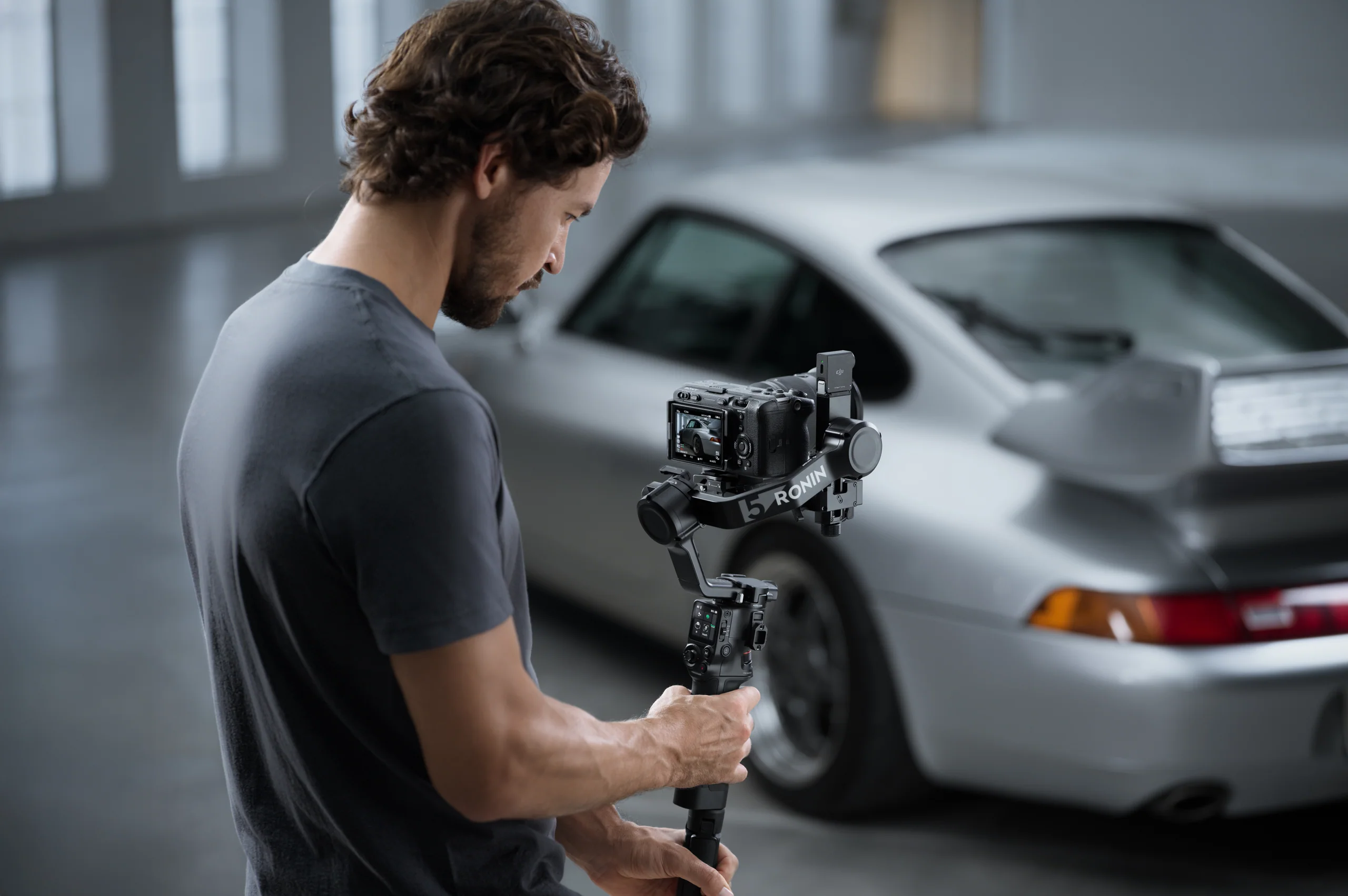 Filmmaker operating a DJI camera stabilizer on location