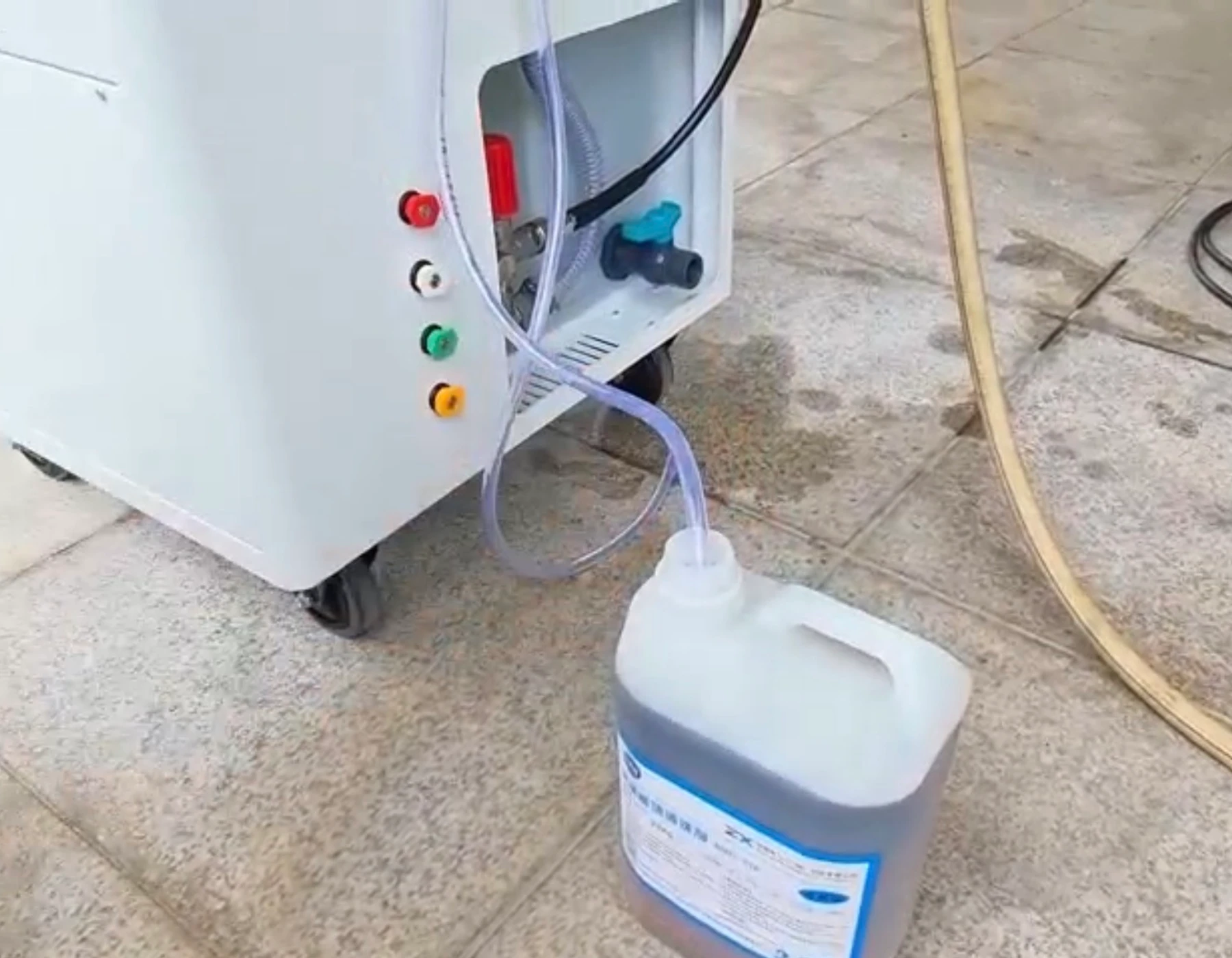 Cleaning solution container connected to the HoverWash Rig 13 detergent feed