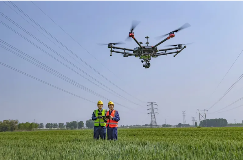 Drone inspecting high-voltage transmission towers