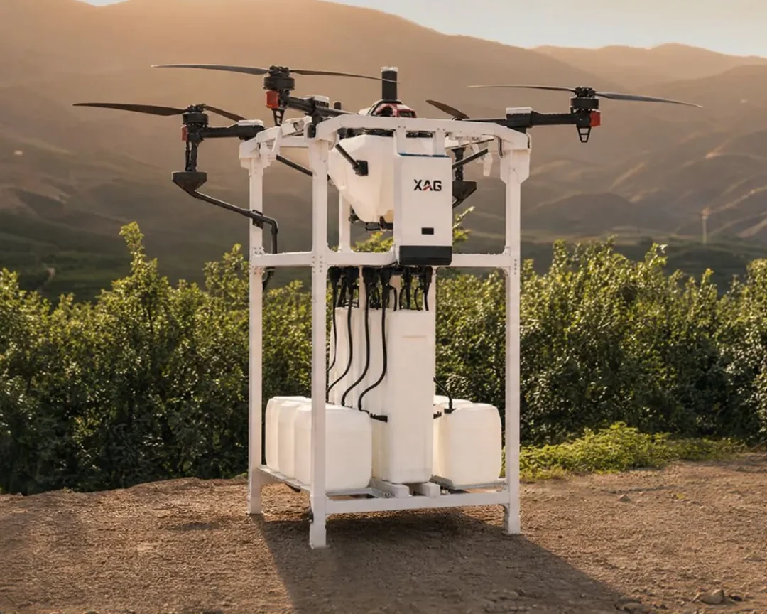 XAG X Series drone, dock and mixing station in an orchard at dusk